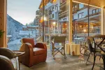 Cozy interior with chairs and large windows showing mountains