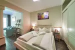 Modern bedroom with a bed and adjoining living area