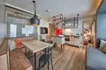 Modern apartment with dining table, kitchen, and seating area