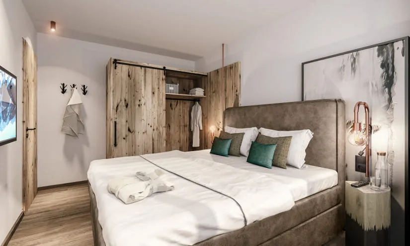 Modernes Schlafzimmer im Thomsn Rock Hotel mit Holzkleiderschrank und Dekokissen.