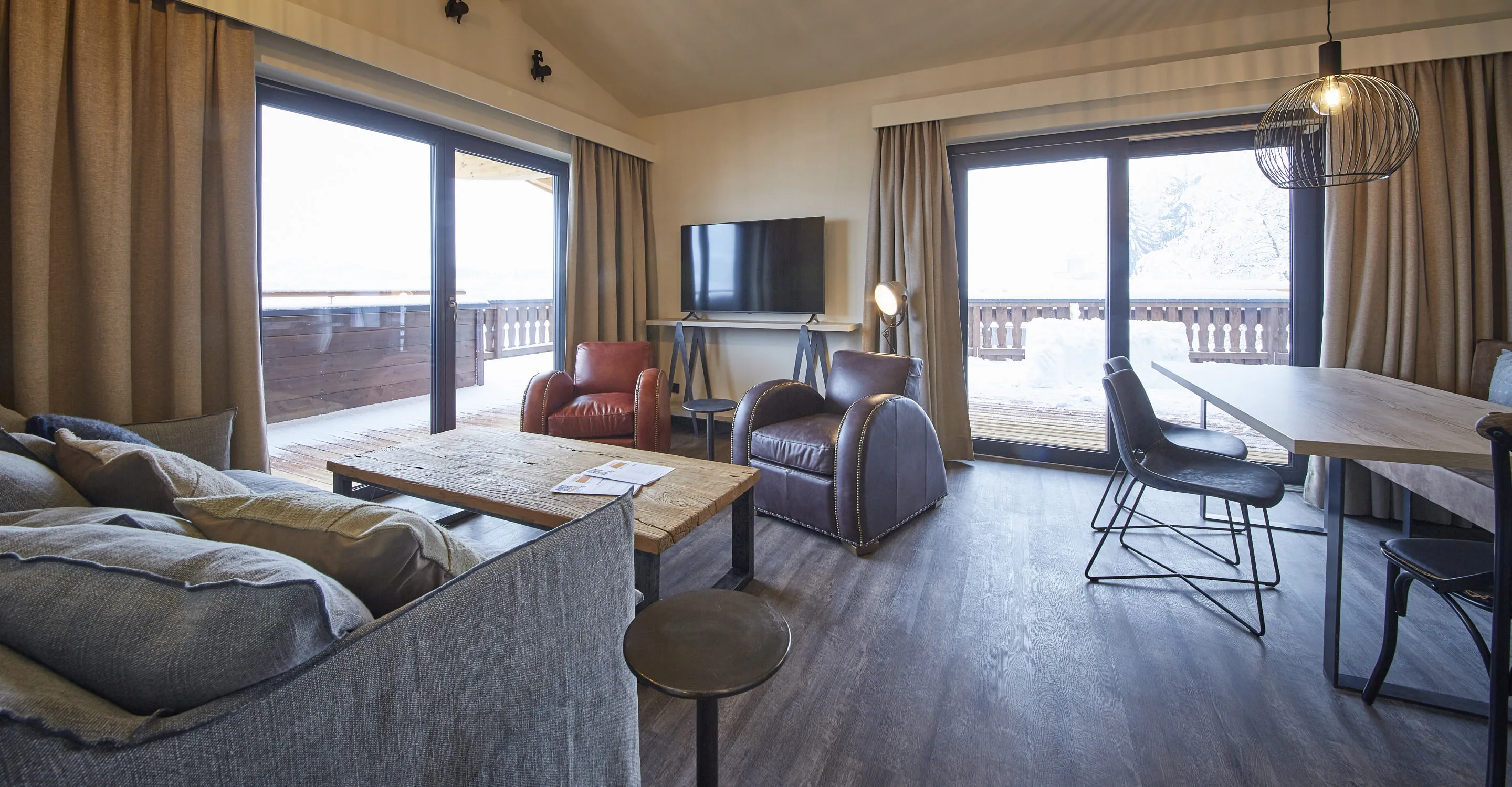 Cozy living area with large windows and modern furniture.