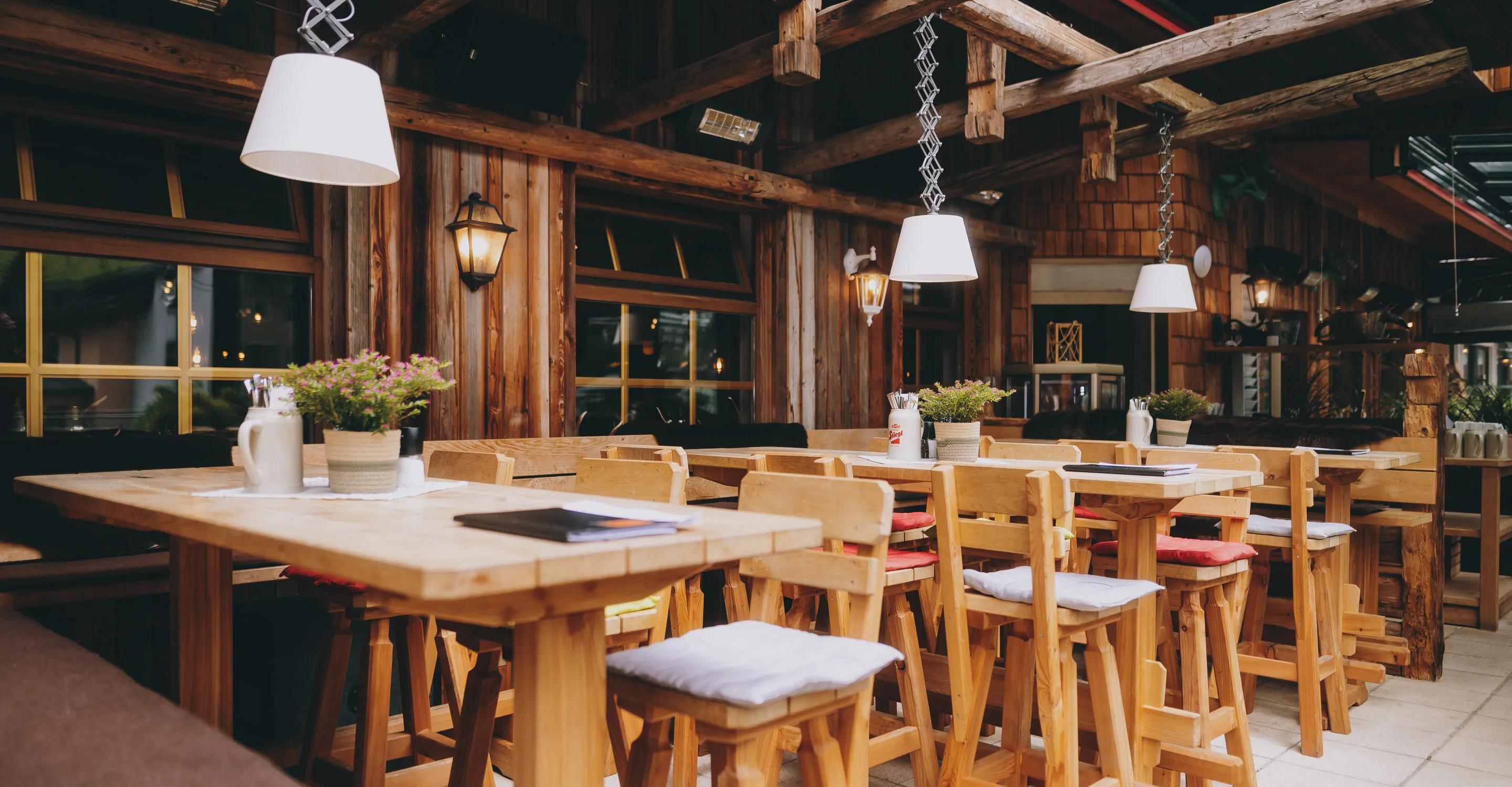 Wooden interior of a cozy restaurant with tables and chairs