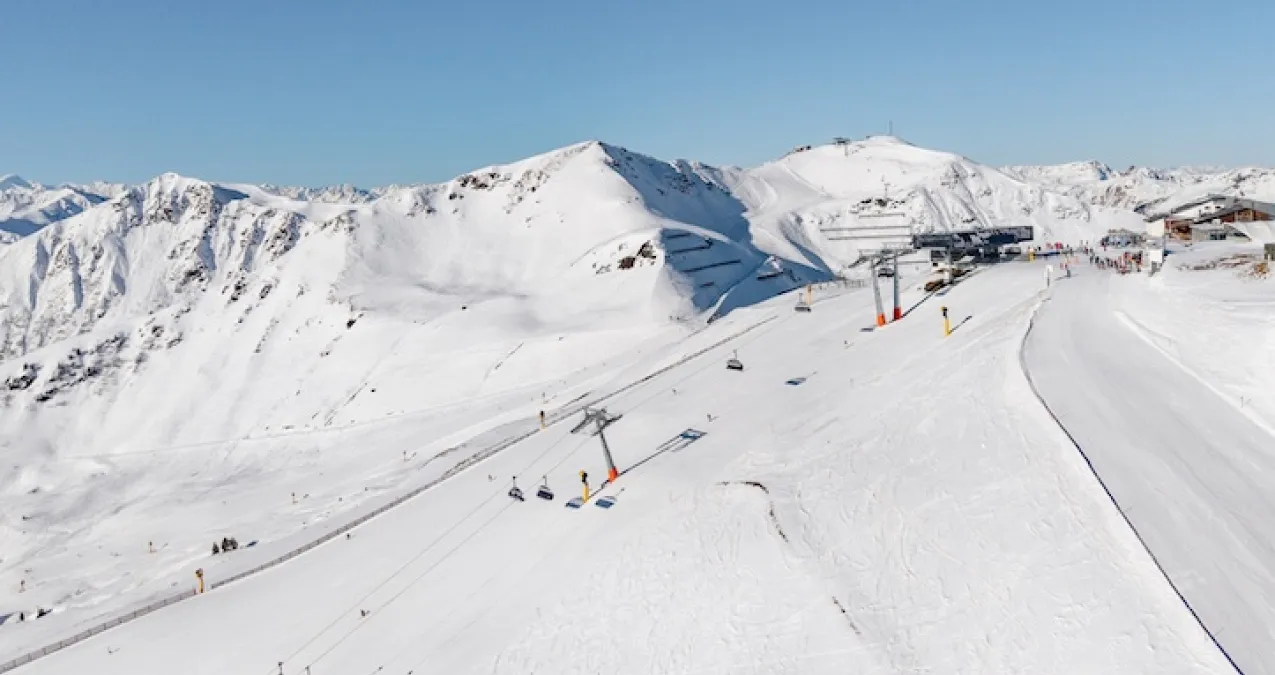 Snowy mountain landscape with ski lifts and slopes