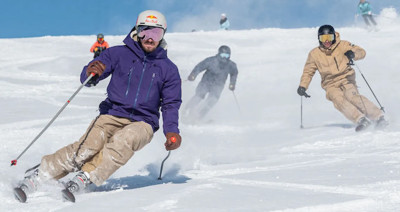 Skiers on snowy slopes, Blue sky in the background