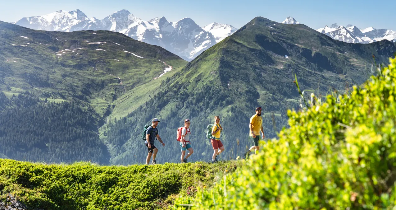 Wanderer genießen die Aussicht in Saalbach Hinterglemm mit Bergen im Hintergrund