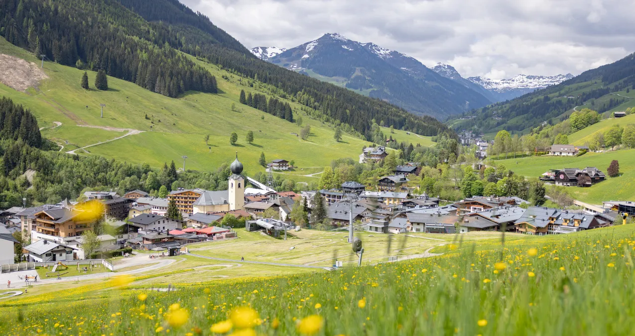 Panorama of Saalbach with green meadows and mountains