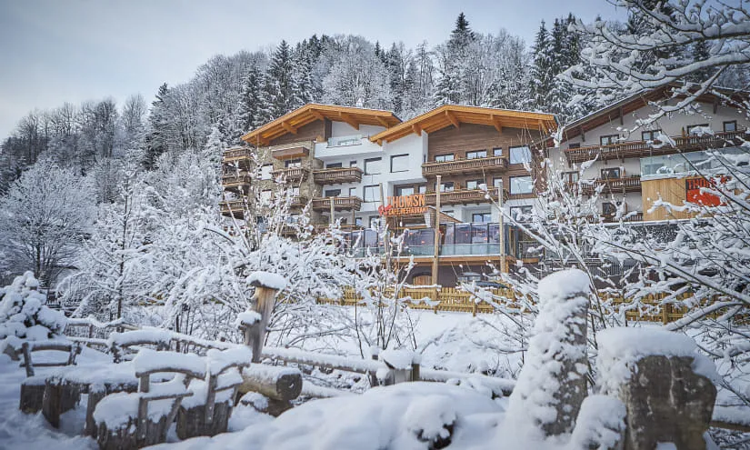 Winter view of a building in the mountains, surrounded by snow