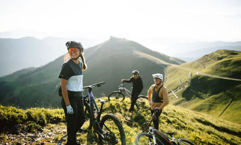 Three mountain bikers in the mountains summer 2023